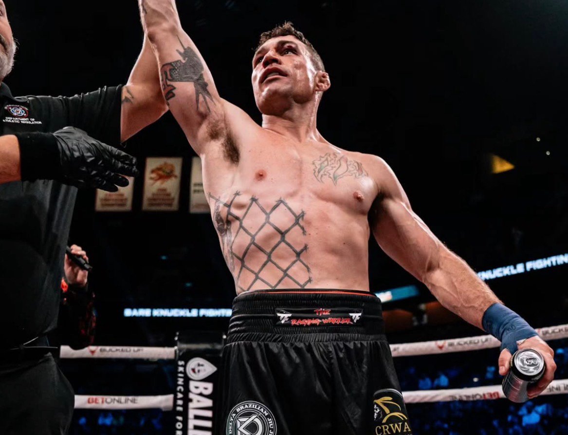 Joey Gambino with his arm raised in victory in the BKFC ring